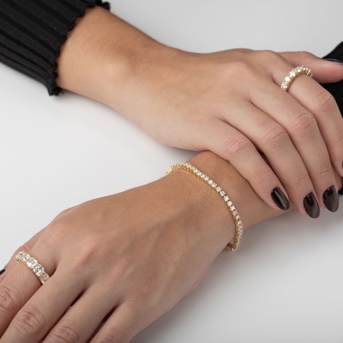 Tennis Bracelet Moissanite Silver 925 worn on hands with matching rings, showcasing elegance and style.