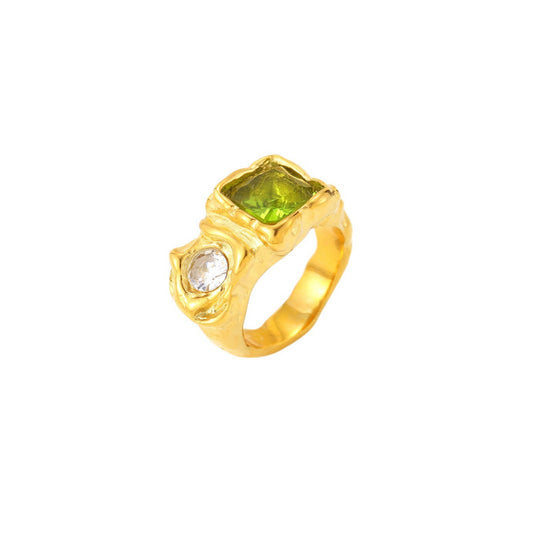 Gold ring with a green gemstone on a white background