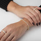 Tennis Bracelet Moissanite Silver 925 worn on hands with matching rings, showcasing elegance and style.