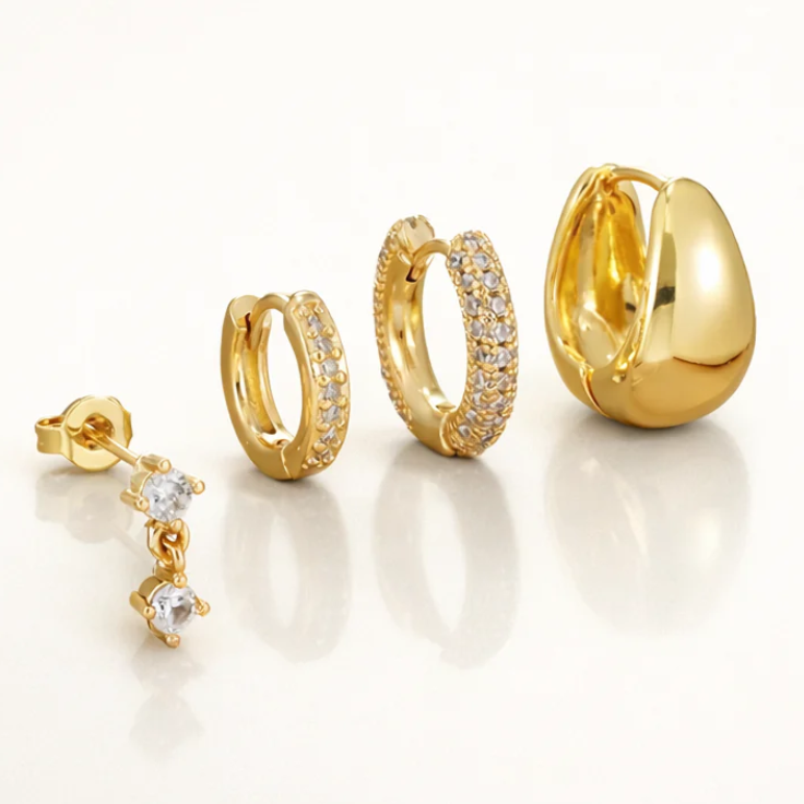 Mini Huggies Earrings set in gold featuring elegant designs and dazzling details, perfect for any occasion.
